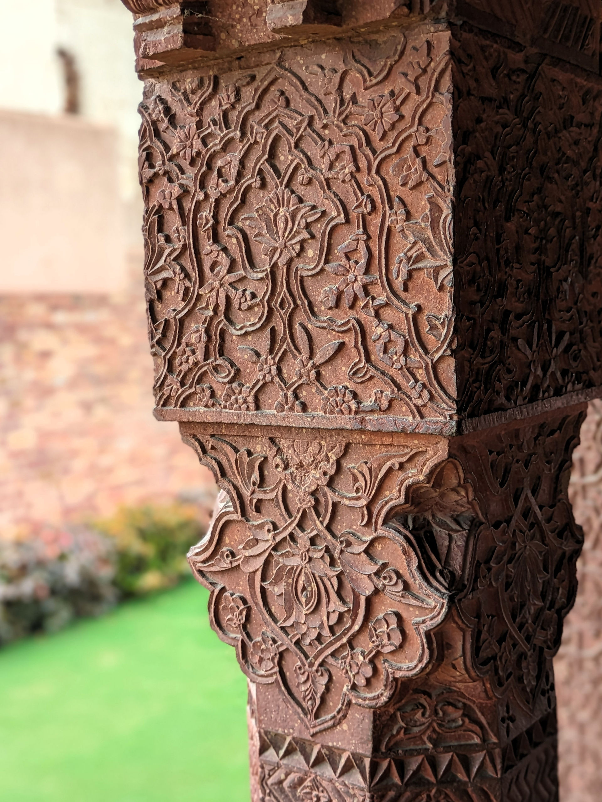Stone column with intricate carvings in the temple complex of Fatehpur Sikri, India