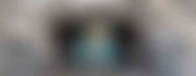 One of the Aberdeen street art murals under a granite archway.