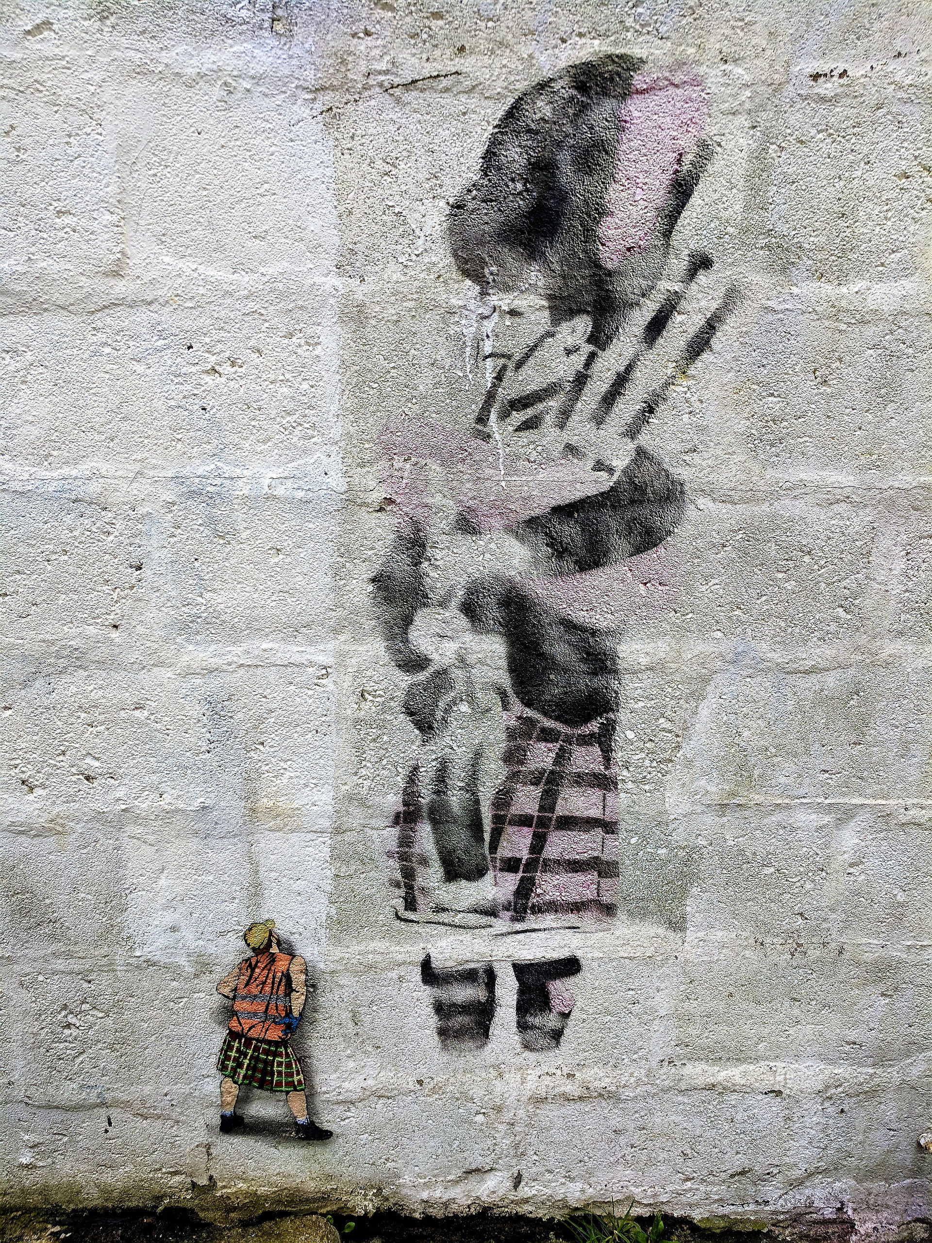 One of the Aberdeen street art murals on a building depicting a Scottish piper.