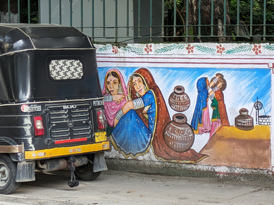 Colourful street art of female figures with water vessels, making it one of the attractions you should visit in Udaipur, India
