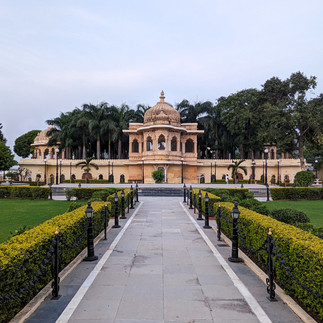 Sand coloured building on Jagmandir set in a manicured green garden, making it one of the attractions you should visit in Udaipur, India