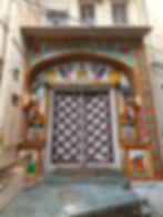 Colourful and intricate painted motiffs on a door way, making it one of the attractions you should visit in Bundi, India.