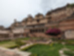 A sand coloured palace with a small garden, making it one of the attractions you should visit in Bundi, India.