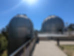 Two telescope domes with a bright sun above during a family day out in the East Bay region.