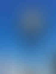 A colourful ornate sign for a pub, with lovely landscape behind it making the area a perfect place to find the enchanted fairies of Scotland