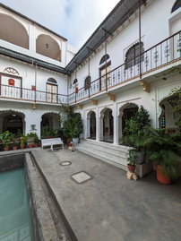 Dev Niwas hotel. Courtyard with a small pool in the middle and columned passageways circling the courtyard, making it one of the attractions you should visit in Bundi, India