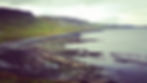 A rocky beach bordered by the sea and hills, making this castle one of the best things to see and do in Skye