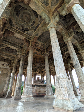 84 Pillered Cenotaph. Inside a stone monument with many columns and a plinth in the middle with a phallic symbol rising up from it, making it one of the attractions you should visit in Bundi, India