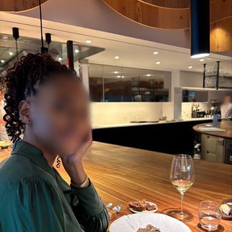 Nala Rose -  Unfiltered photo at a fine-dining table, green top with a glass of wine