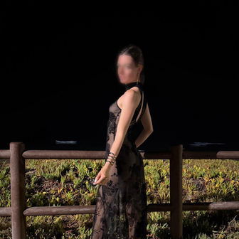 Lou - Unfiltered shot in a sheer black dress by a wooden fence at dusk