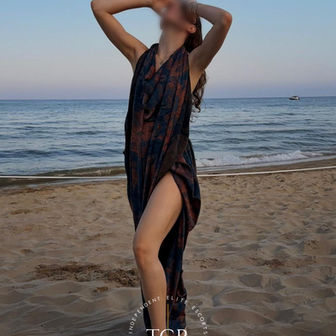 Lou - Unfiltered shot in a sheer black dress on a beach at sunset