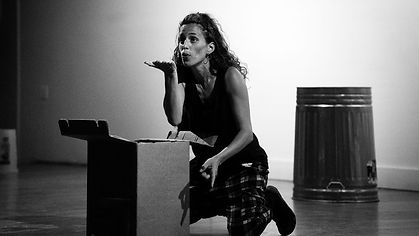 A greyscale photo of a performer kissing the air with her hand out
