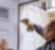 Man installing white door using drill