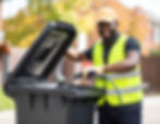 Firefly_Local Council workman with a hi-viz jacket and a cap, bin washing with a pressure 