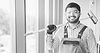 Smiling cleaner holding window cleaning tool