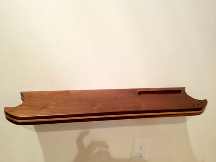 Walnut floating shelf with maple inlay. Finished in shellac. 