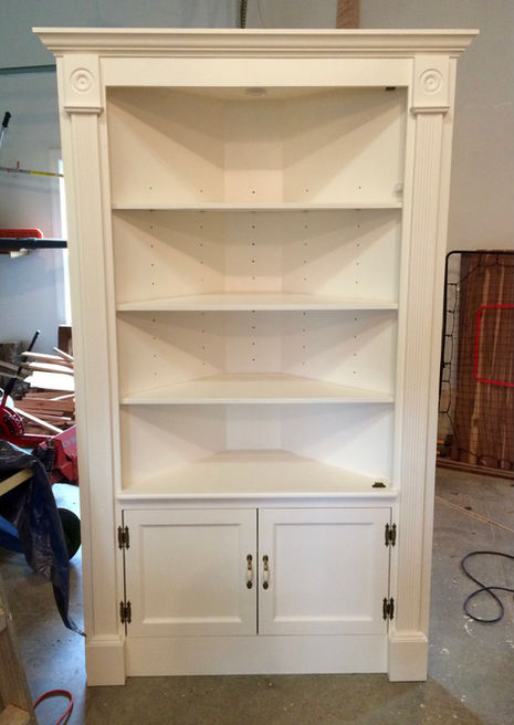 Built-in corner cabinet. Integrated door light; finished in Sherwin Williams paint.