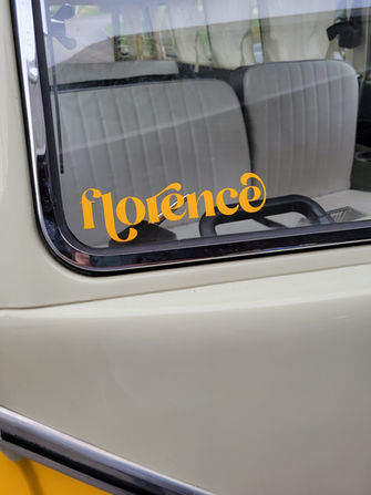 Image of the front of the yellow bus window with the sticker "Florence"