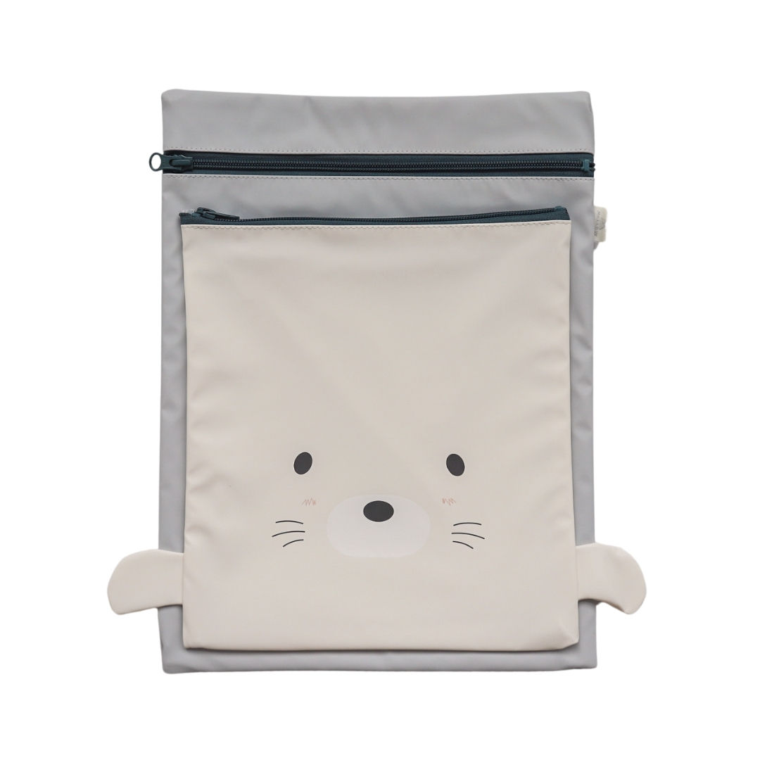 The Mellow Eco Wet Bag - Seal, with a cute seal face, offers a functional and playful way for parents to carry wet or dry
