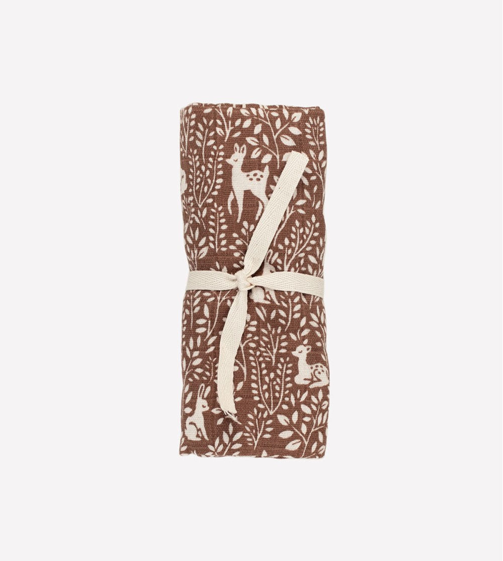 Main Sauvage 100% Cotton Woodland Baby Swaddle rolled up, showcasing charming forest animal print for soothing swaddles.