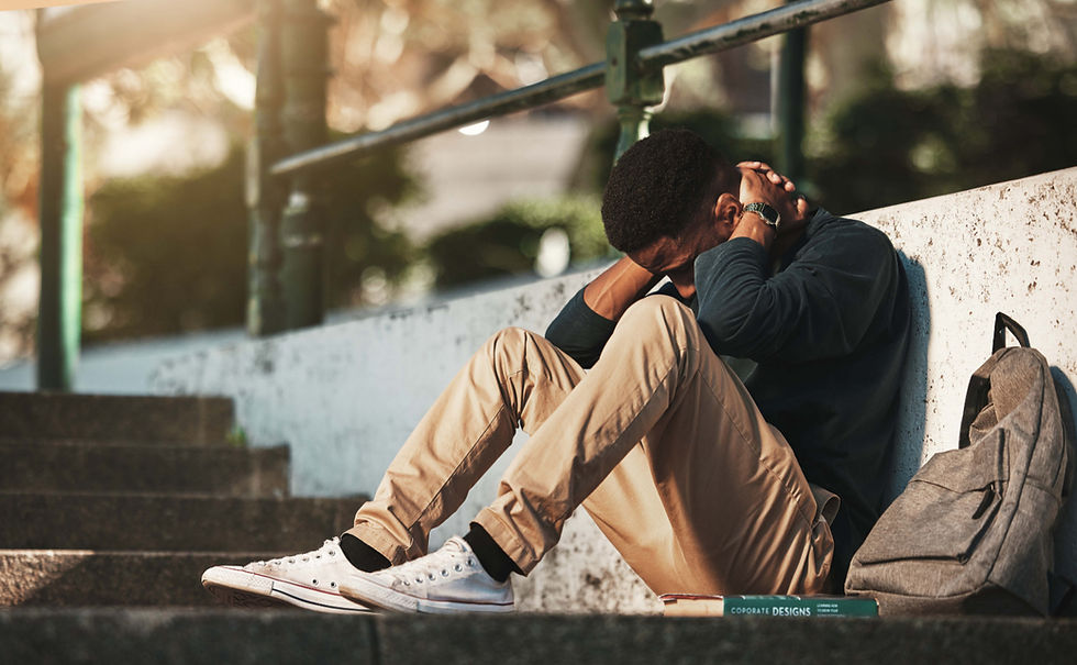 Man sitting on stairs showing signs of bipolar depression.