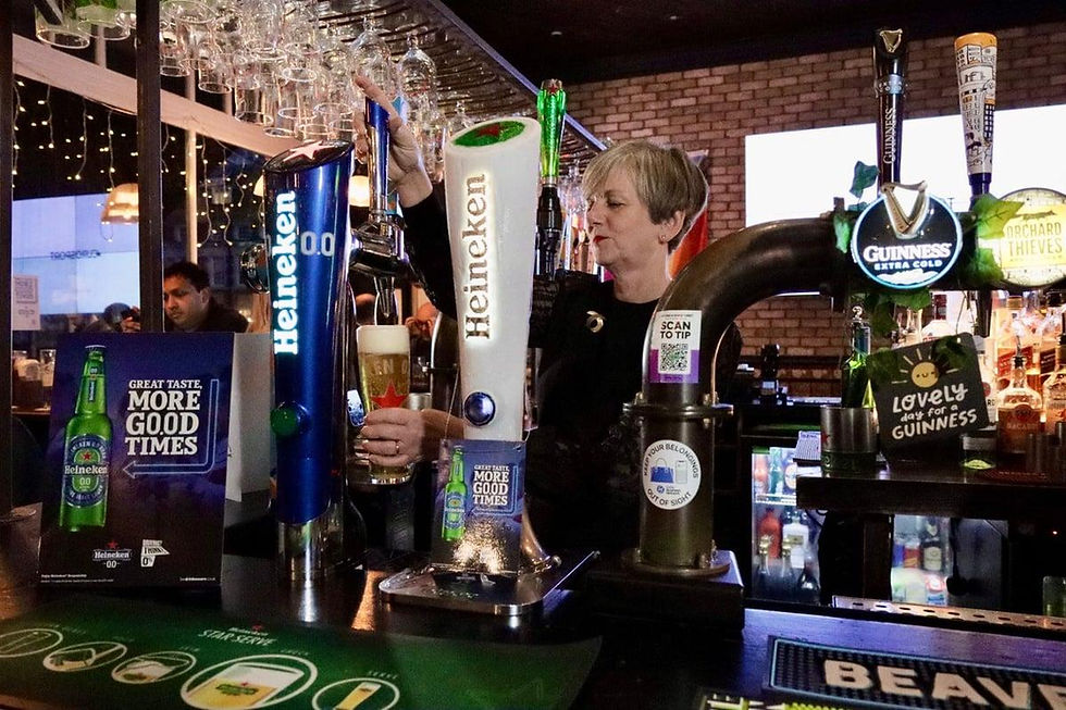 Alcohol-free beer taps and 0.0% branding on a modern pub bar.