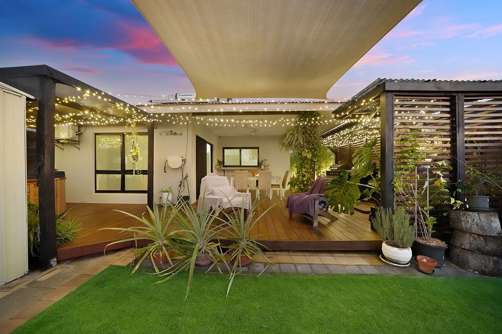 Wide angle view of a house exterior during twilight with warm interior lights