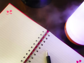an open journal on a table with humidifier