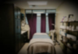 Spa treatment room with massage table, ready for clients