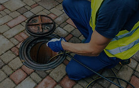Drainage specialist using high-pressure jetting equipment to clear a blocked drain on the homepage hero section