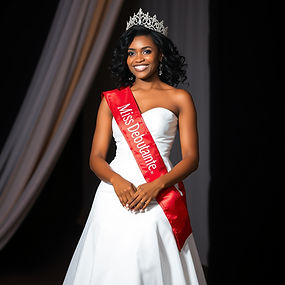 black woman pageant dressed in white dress, red sash saying 'Miss Debutante'.jpg