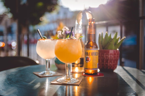 Cocktails and authentic beverages from Spain,  Latin America presented on the terrace table of Taco Paco Restaurant Ibiza.