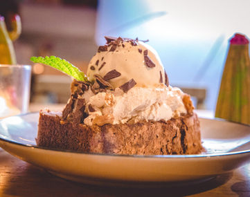 A ice cream and cake dessert on a plate
