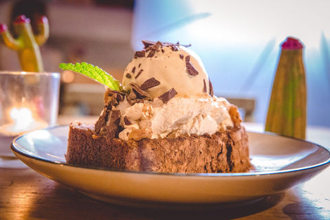 A ice cream and cake dessert on a plate