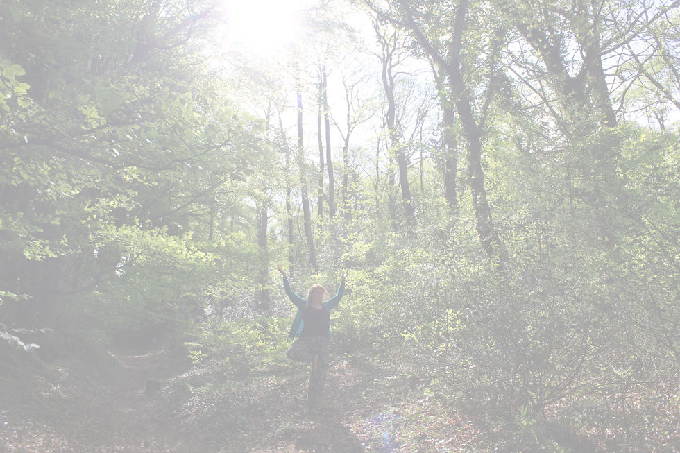 Nicci in Tree Pose surrounded by trees.