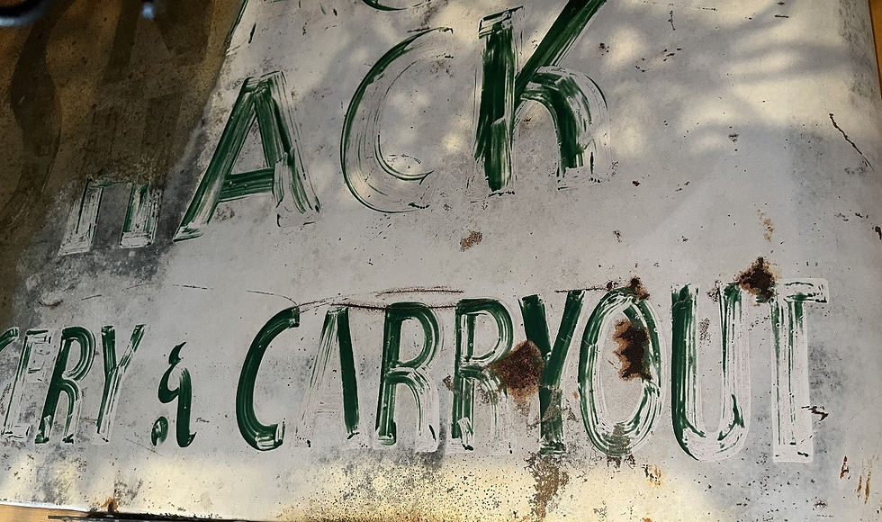 Here is a photo of what is left of the old Snack Shack sign. It said Snack Shack, Bakery and Carryout. 