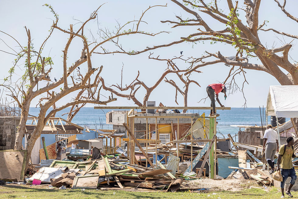 A man begins to rebuild in the debris left by Hurricane Melissa. Whitehouse, Westmoreland