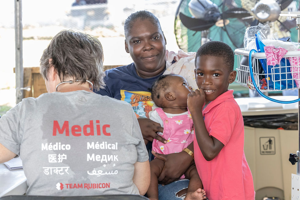 A nurse tends to a young family. Savanna La Mar, Westmoreland
