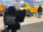 A DSLR camera recording video of large equipment.