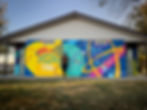 Jeanette Johnson muralist in front of large park mural in Wayne nebraska