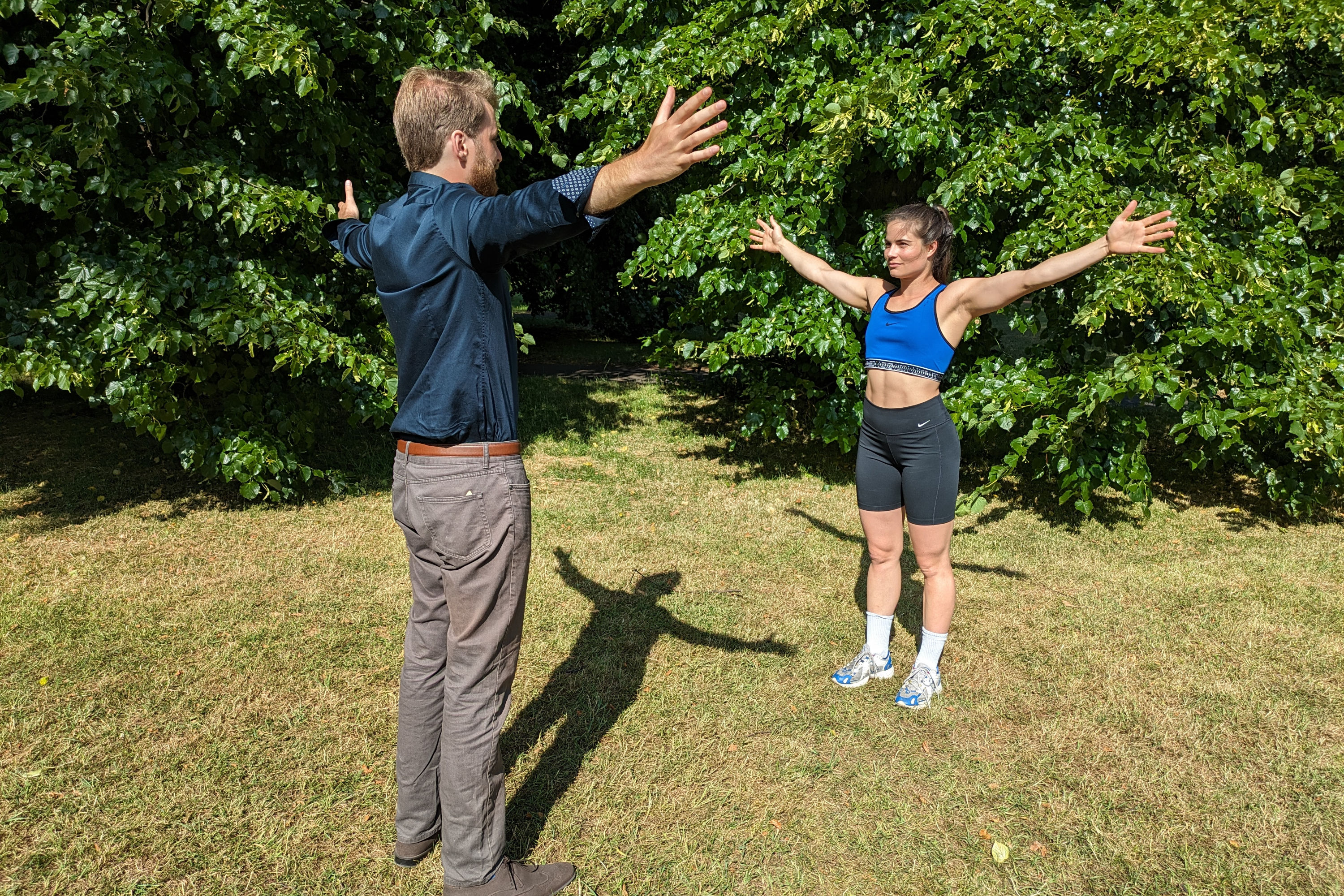Edward Walsh guiding a model on her exercise form