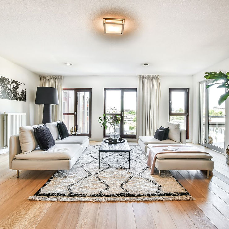 a well lit living room with black and white furnishings