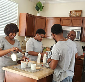 Sasha Sass Candles hand-pouring candles in kitchen.