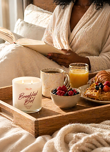 Breakfast in Bed soy candle on wooden tray with coffee, orange juice, berries, and waffles