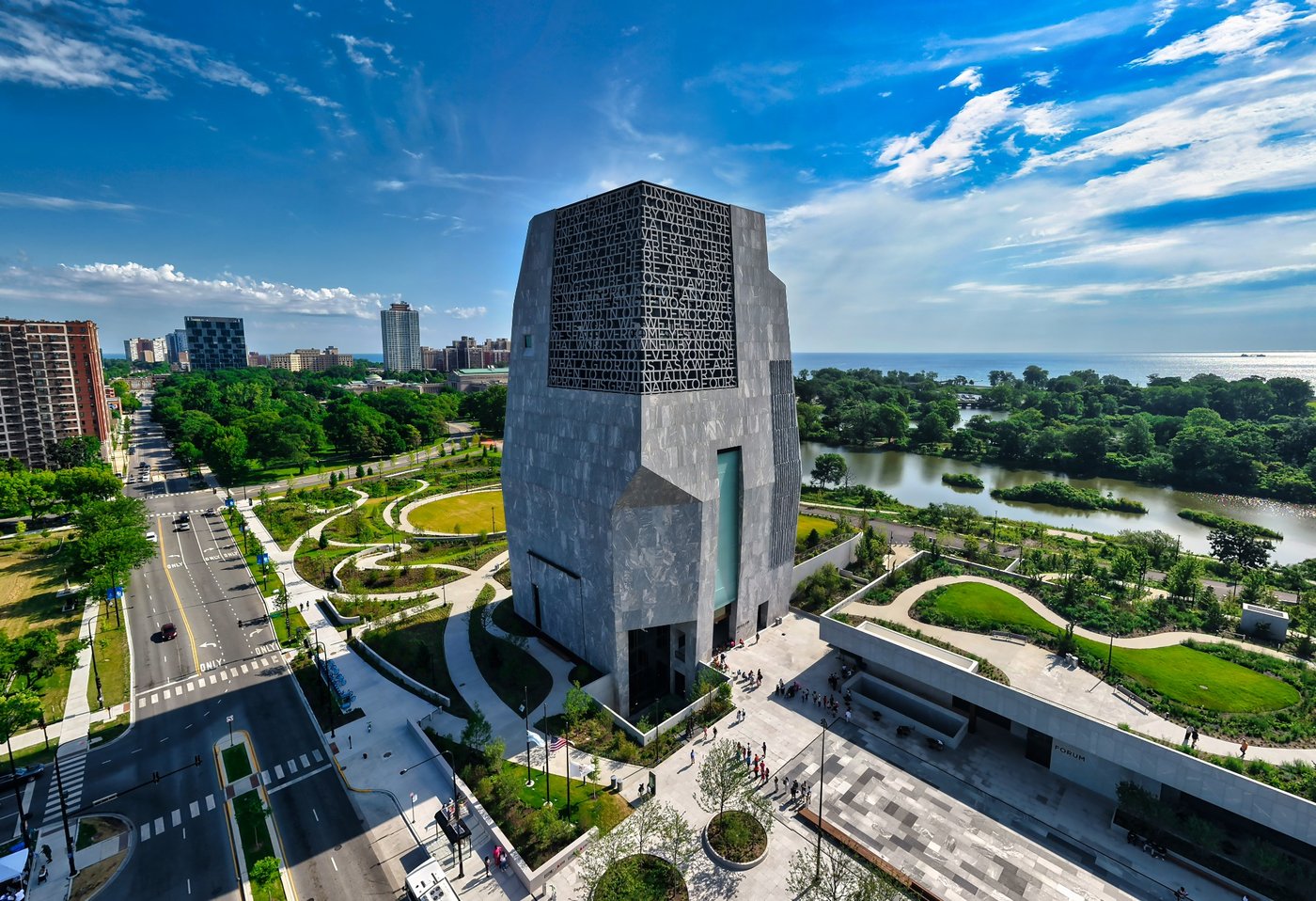 A Voice Set in Stone Tall stone building with an inscribed facade amid landscaped paths near the Chicago lakefront.