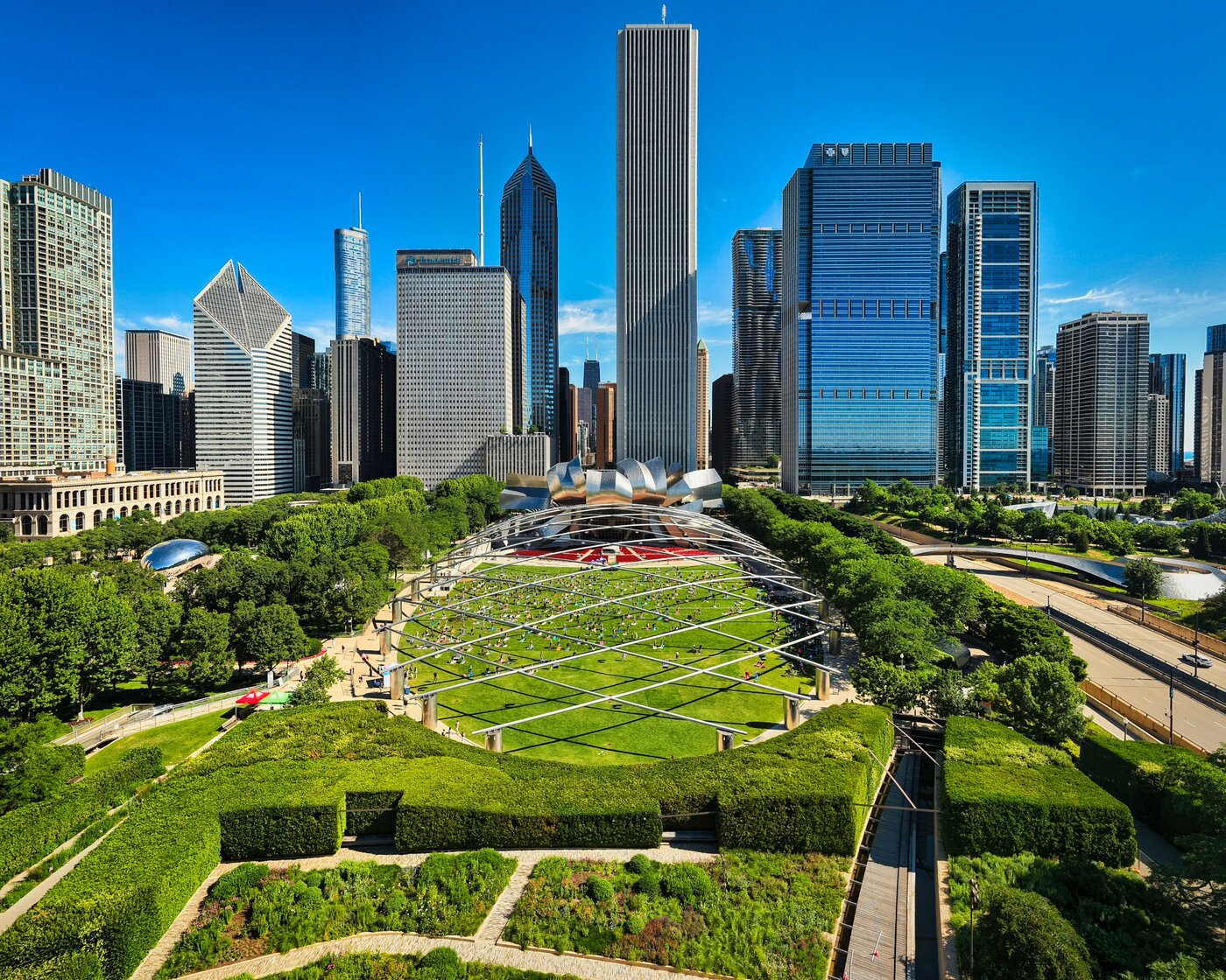 Geometric park paths across a green lawn beneath Chicago skyscrapers.