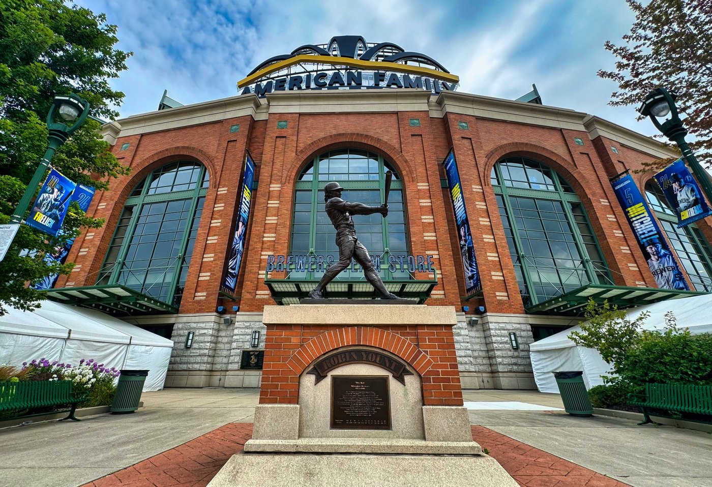 Stepping Up to the Plate Bronze baseball batter statue outside the brick facade of American Family Field.