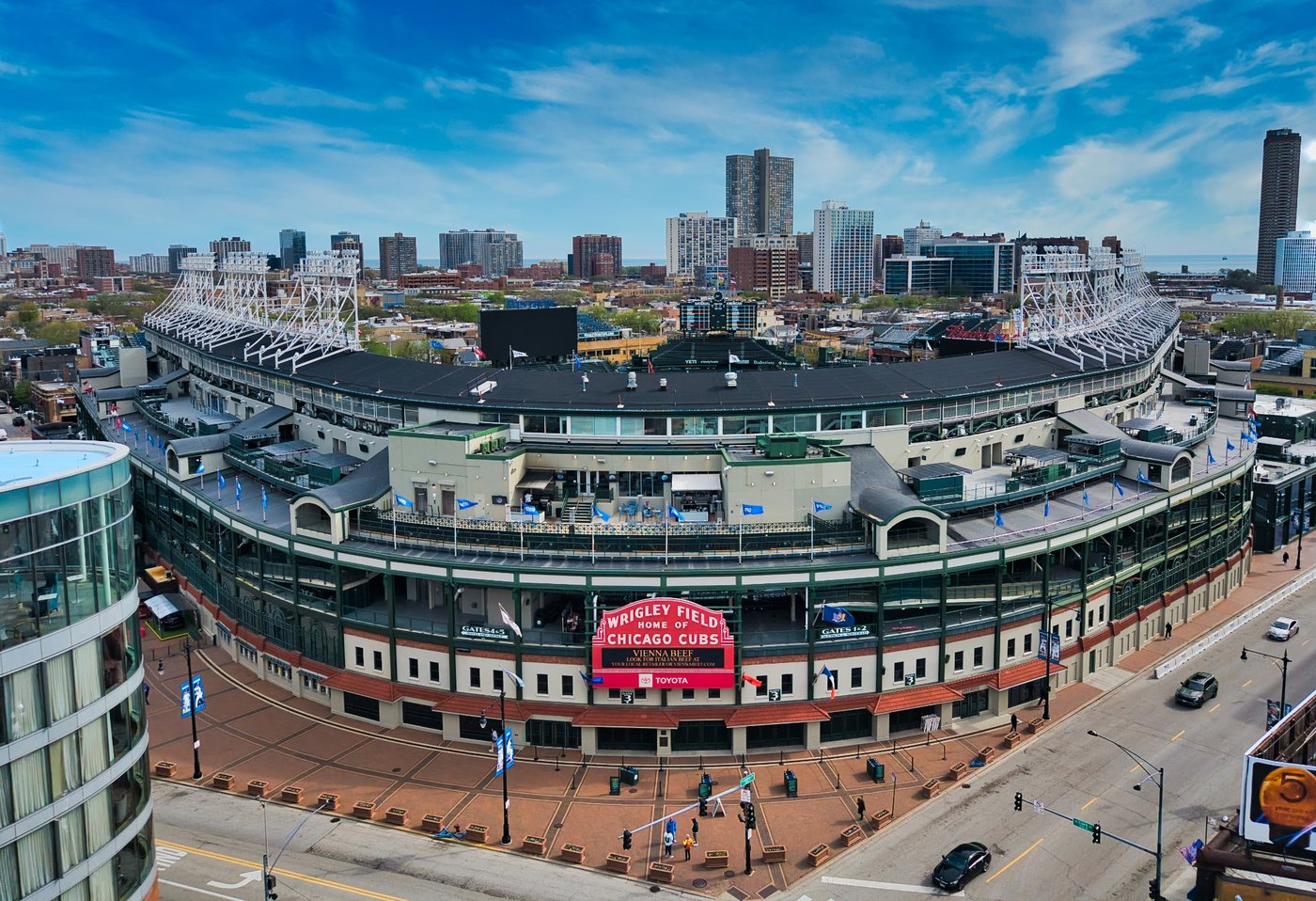 Above the Friendly Confines Aerial view of Wrigley Field entrance and surrounding Chicago neighborhood in daylight.