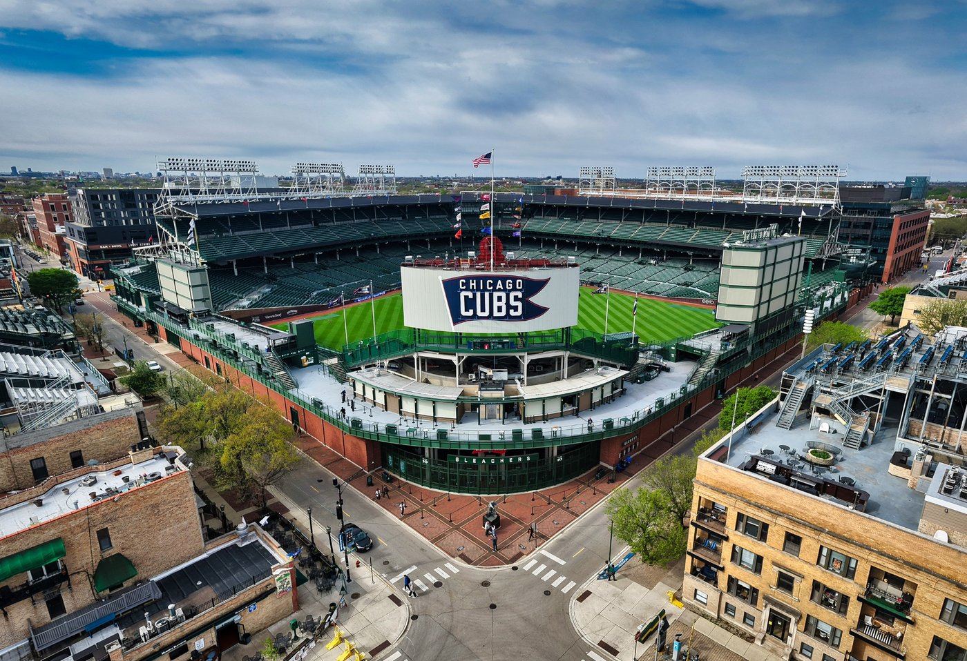 Around the Ballpark Elevated view of Wrigley Field's Cubs sign and the intersection outside the stadium.