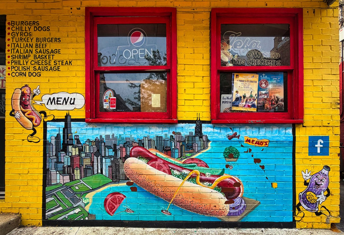 At the Serving Window Yellow food stand with red windows, menu lettering, and a hot-dog and Chicago skyline mural.